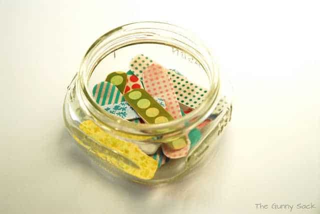 a jar with decorative bandages inside.