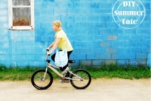 a girl riding a bike.