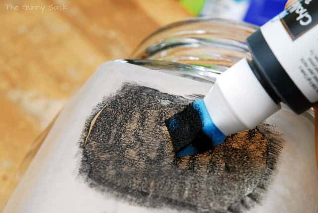 A sponge paint applicator applying paint to a glass.