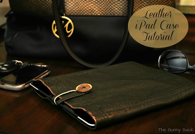 An iPad tablet in a handmade leather case.
