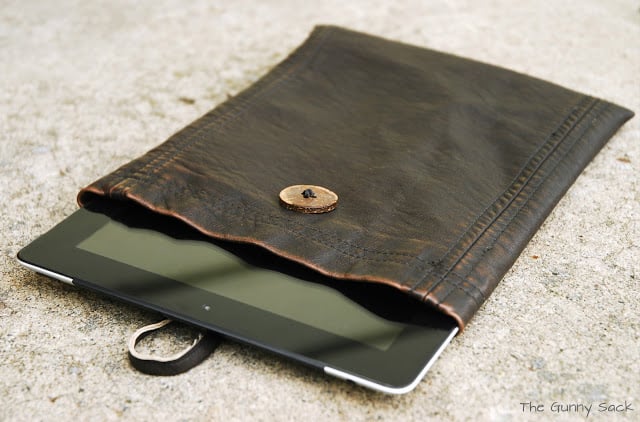 an iPad tablet in a leather case.