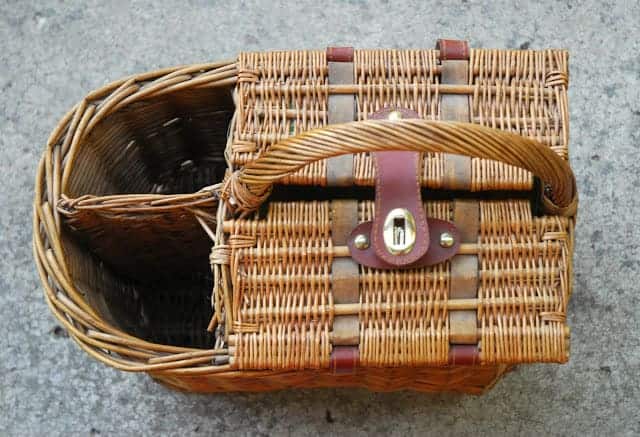 a wicker picnic basket with a handle.