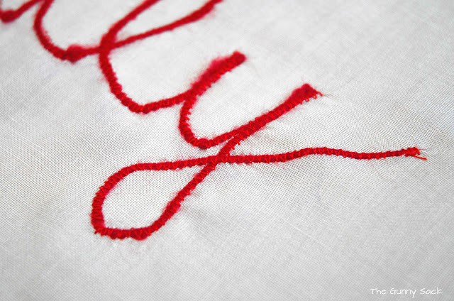 red stitching on a piece of fabric.