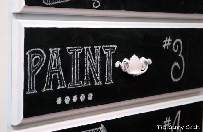 White chalk lettering on a drawer front.
