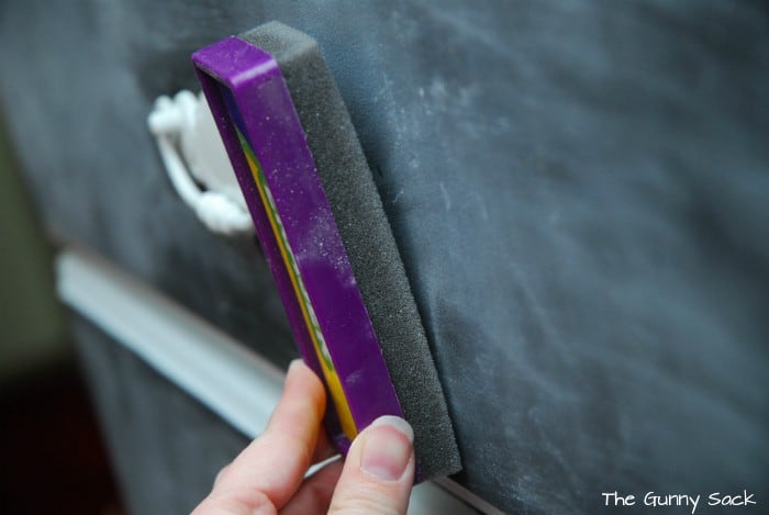 a hand holding a chalkboard eraser.