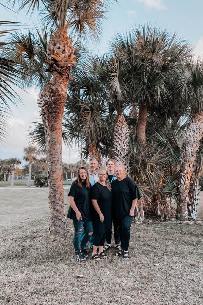 the gunny sack llc team with palm trees.
