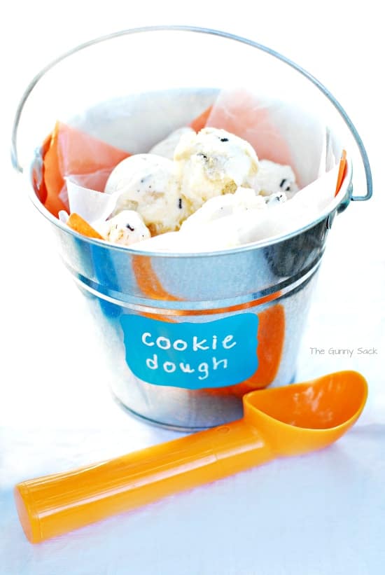 Scoops of cookie dough ice cream in a metal pail.