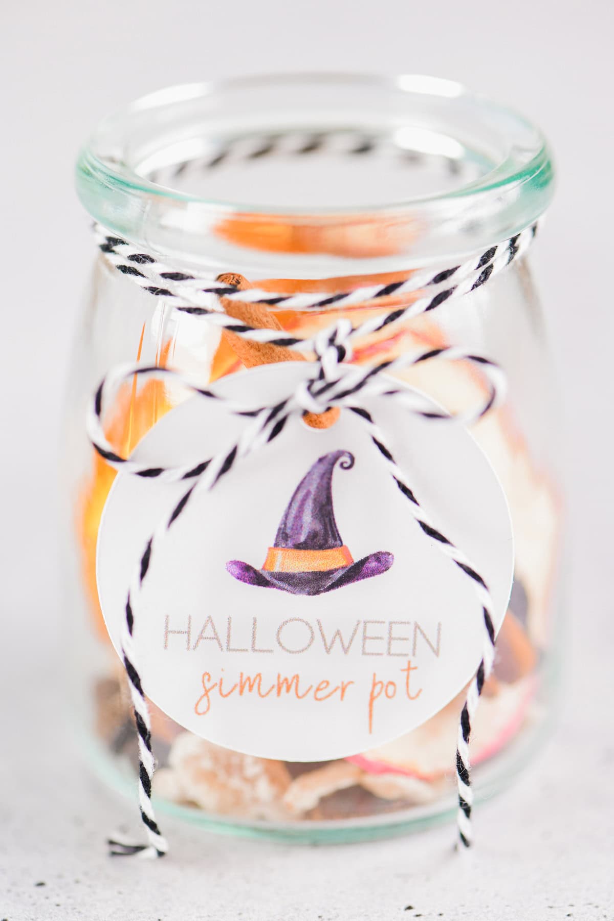 Halloween simmer pot label on jar with black and white baker's twine.